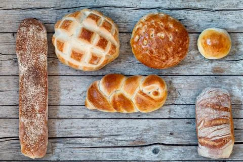 Various Bread Types On Wood Background Stock Photos