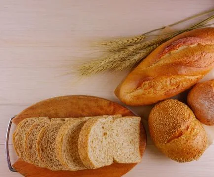 Various breads on wooden table Stock Photos