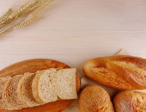 Various breads on wooden table Stock Photos