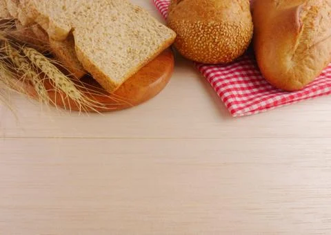 Various breads on wooden table Stock Photos