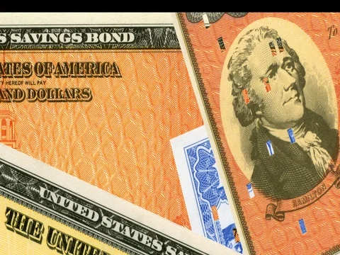 Various brightly colored $1000 United States savings bonds. Stock Footage