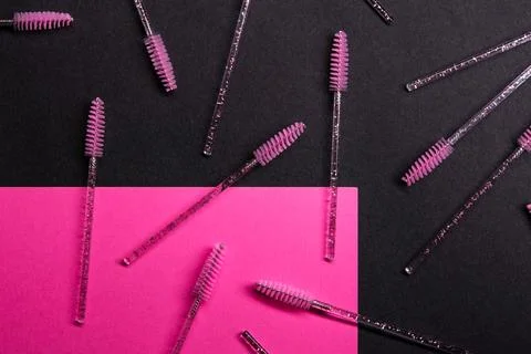 Various brow brushes placed on a dark surface with bright pink accents and .. Stock Photos