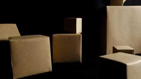 Various brown cardboard boxes standing on dark background Stock Photos