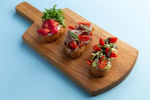 Various bruschettas on the board. Stock Photos