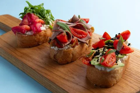Various bruschettas on the board. Stock Photos