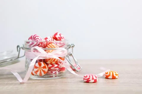 Various candy and sweets on the table on a colored background. Stock Photos