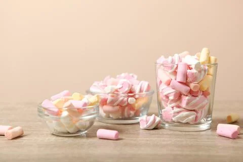 Various candy and sweets on the table on a colored background. Stock Photos