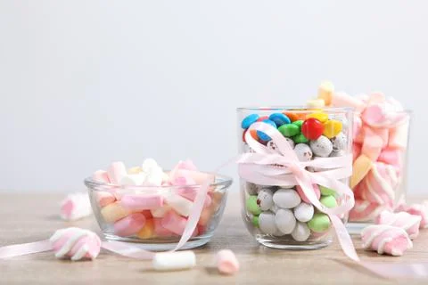Various candy and sweets on the table on a colored background. Stockfoto's