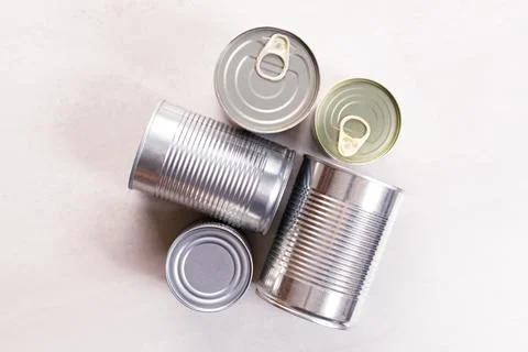 Various canned vegetables on kitchen table background. Photos