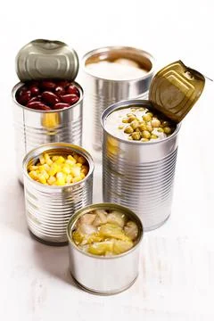 Various canned vegetables on kitchen table background. Foto stock