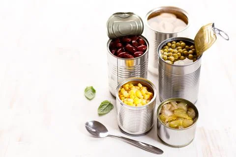 Various canned vegetables on kitchen table background. Foto stock