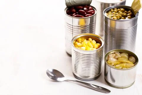 Various canned vegetables on kitchen table background. Foto stock