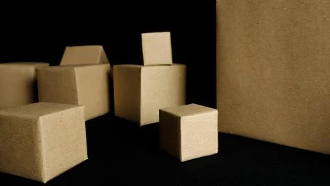Various cardboard boxes creating abstract shapes on black Stock Photos