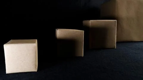 Various cardboard boxes on dark black background Stock Photos