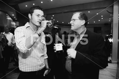 Various Caucasian people at wine tasting event Stock Photos