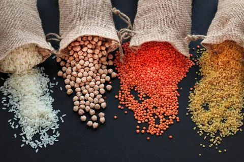 Various cereal on black surface Stock Photos