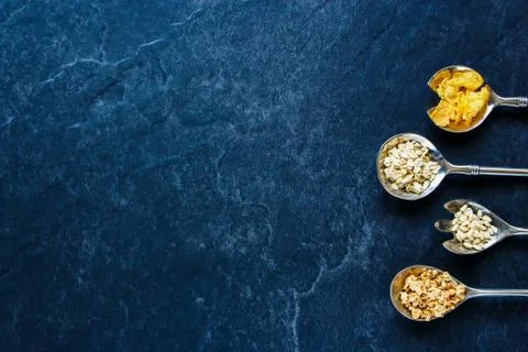 Various cereals in spoons Stock Photos