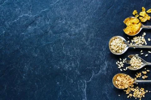 Various cereals in spoons Stock Photos