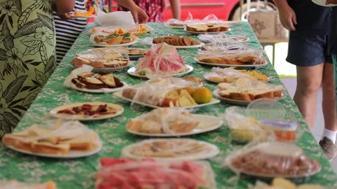 Various cheap snacks cut in pieces, served on table and wrapped in stretch film Stock Footage 215105374