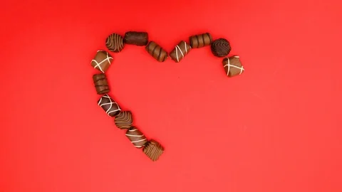 Various chocolates make and fill heart - Stop motion Stock Footage 129746886