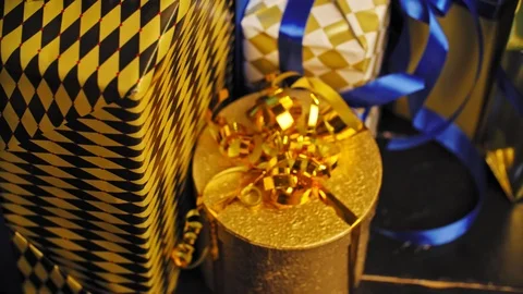 Various Christmas presents under the illuminated Christmas tree. 4K Stock Footage 98683553