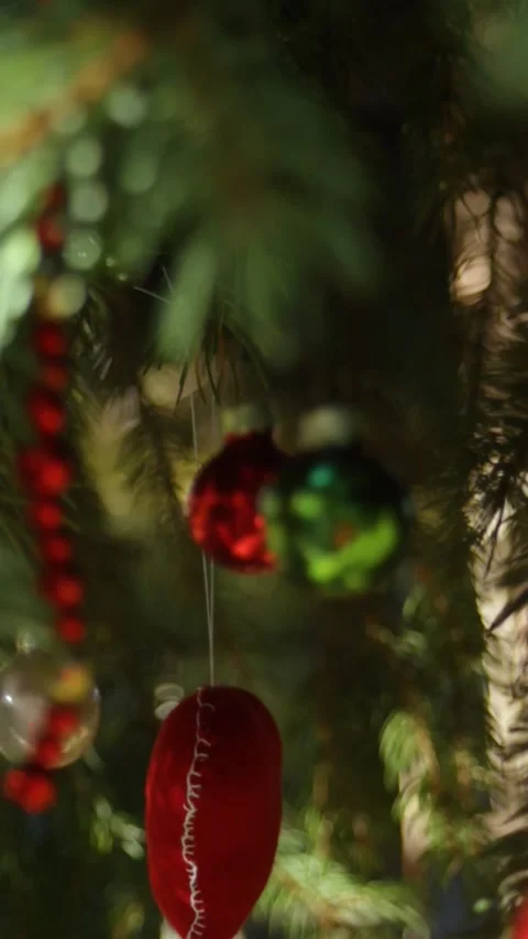 Various Christmas tree decorations on the branches of a tree. Vertical video of Stock Footage 296402405