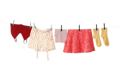 Various clean clothes hanging on a clothesline with clothespins, laundry day  Stock Photos