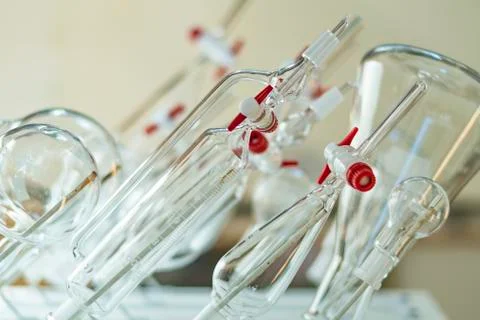 Various clean glssware hanging on the wall in a chemistry laboratory for biot Stock Photos