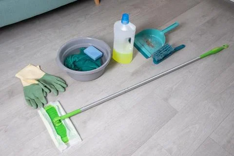 Various cleaning tools and products including mop,  bucket with soapy water Stock Photos