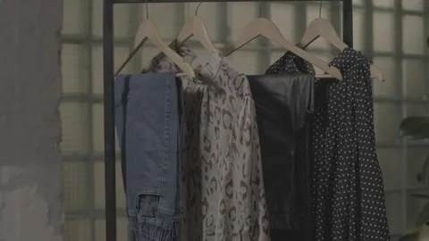Various clothes hanging in the dressing room 32 Video stock 336690715