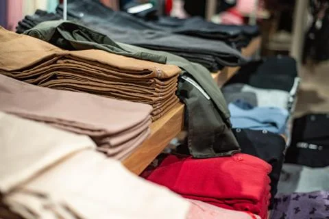 Various clothes on store shelves Stock Photos
