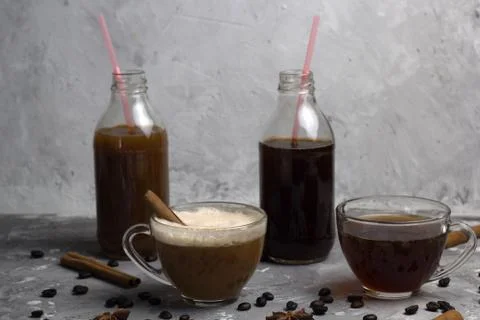 Various of  coffee drinks in different cups and bottles concrete background Stock Photos