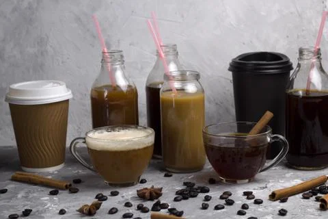Various of  coffee drinks in different cups and bottles concrete background Stock Photos