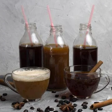 Various of  coffee drinks in different cups and bottles concrete background Stock Photos
