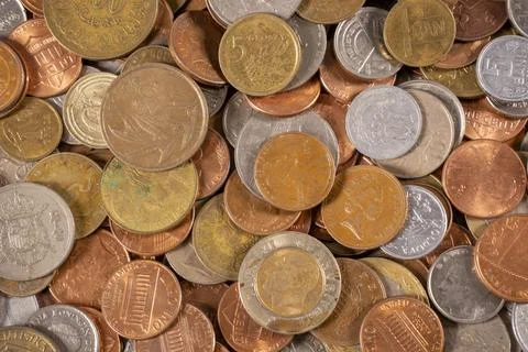 Various coins on a flat surface showing different sizes and colors Stock Photos