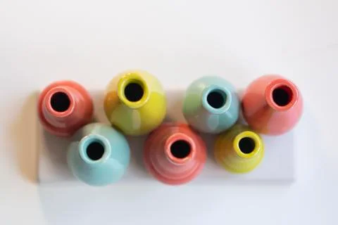 Various colored clay containers Stock Photos