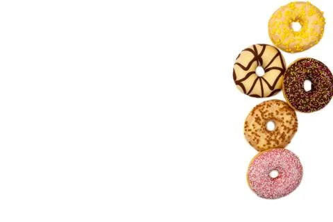 Various colored delicious donuts on white background, space for text Stock Photos