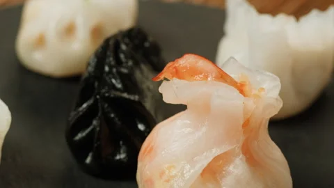 Various of colored dim sum on black plate close-up macro. Steaming Technique Stock Footage 256725537