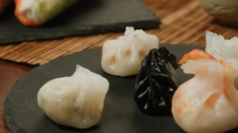 Various of colored dim sum on black plate close-up macro. Steaming Technique Stock Footage 257591027