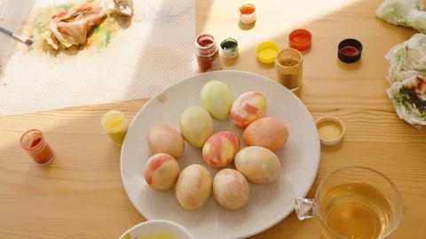 Various Colored Easter Eggs and Painting Supplies Are Arranged Neatly on a Table Stock Photos