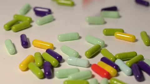 Various colored medicine capsules on a circular pedestal Stock Footage 250488686
