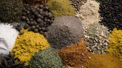 Various colored spices and seasonings rut in the frame top view Stock Footage 123561553