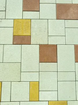Various colored tiles arranged on the ground in a pattern during daylight h.. Stock Photos