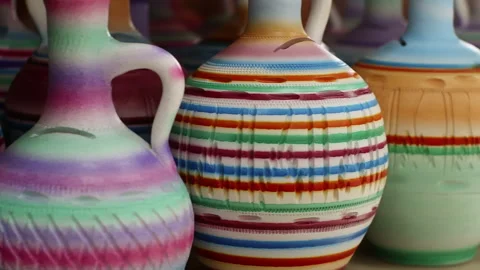 Various colorful clay vases on table at workshop Video stock 301273744