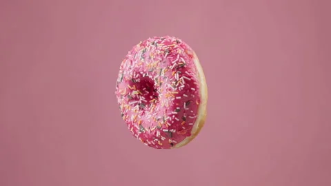 Various colorful donuts. Donuts of different colors changing at pink background. Stock Footage 161562975