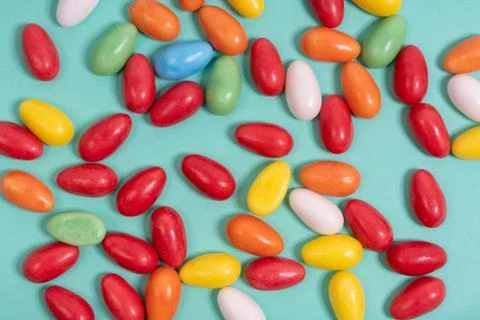 Various colorful Easter eggs spread on an aqua menthe surface Stock Photos