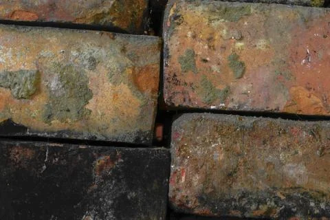 Various Colors Old Bricks Placed One on Each Other Background Surface Stock Photos