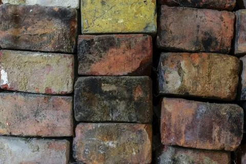 Various Colors Old Bricks Placed One on Each Other Background Surface Stock Photos