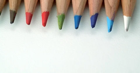 Various colour pencils rolling quickly onto top of frame Stock Footage 113142813