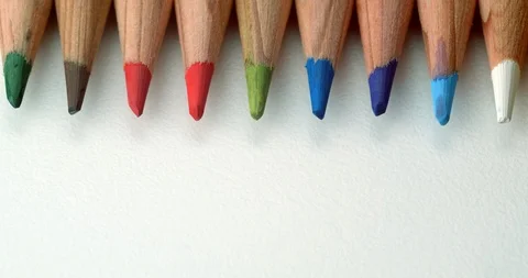 Various colour pencils rolling off top of frame Stock Footage 113142793